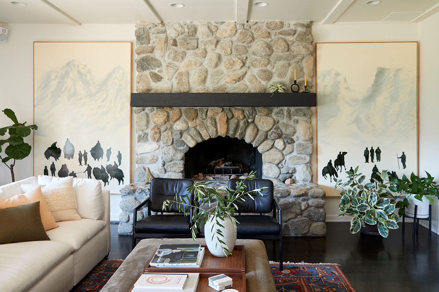 living room with fireplace and artwork on either side.