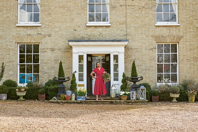 Paula Sutton in front of her home in the country