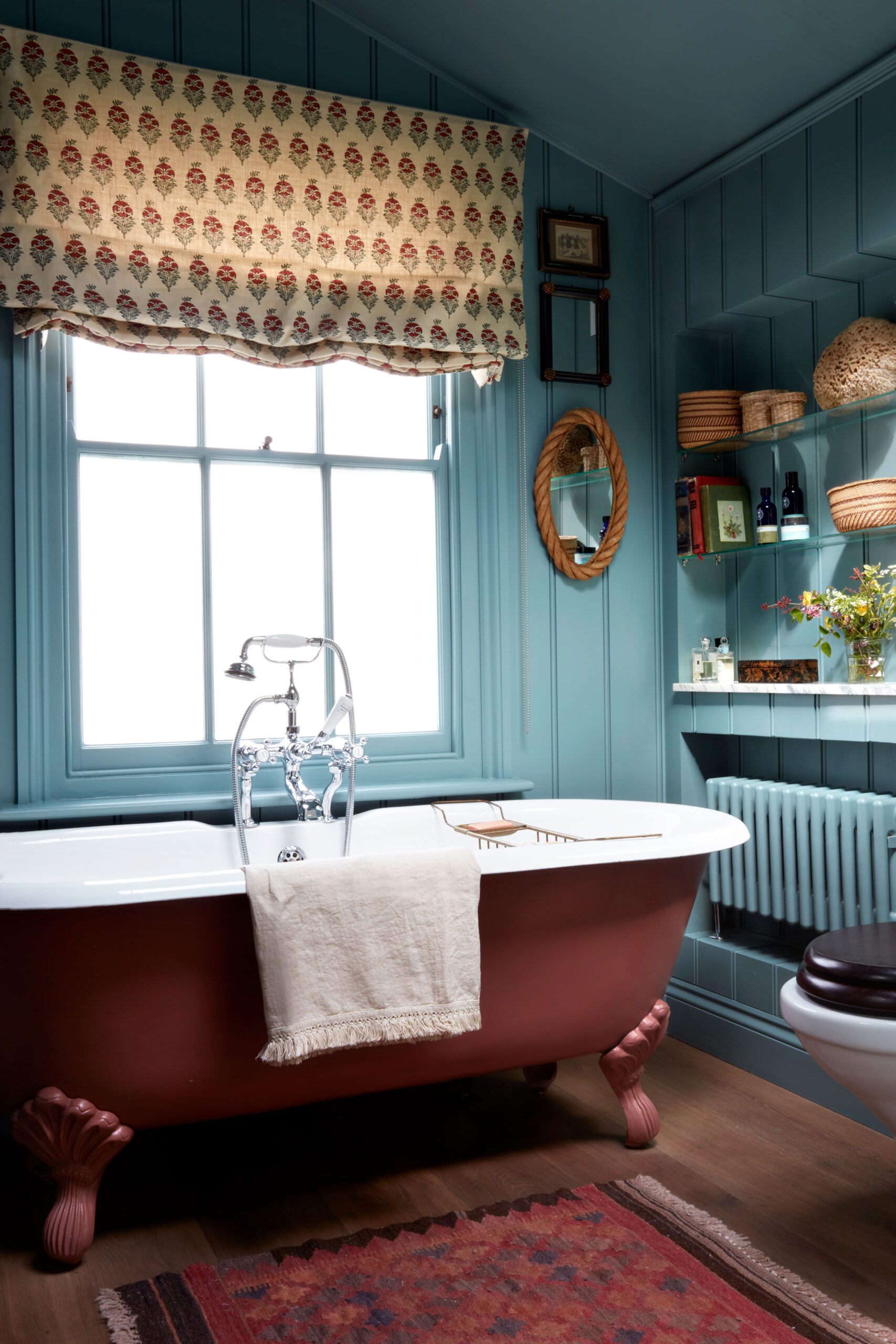 Blue Bathroom With Wainscotting and brown tub