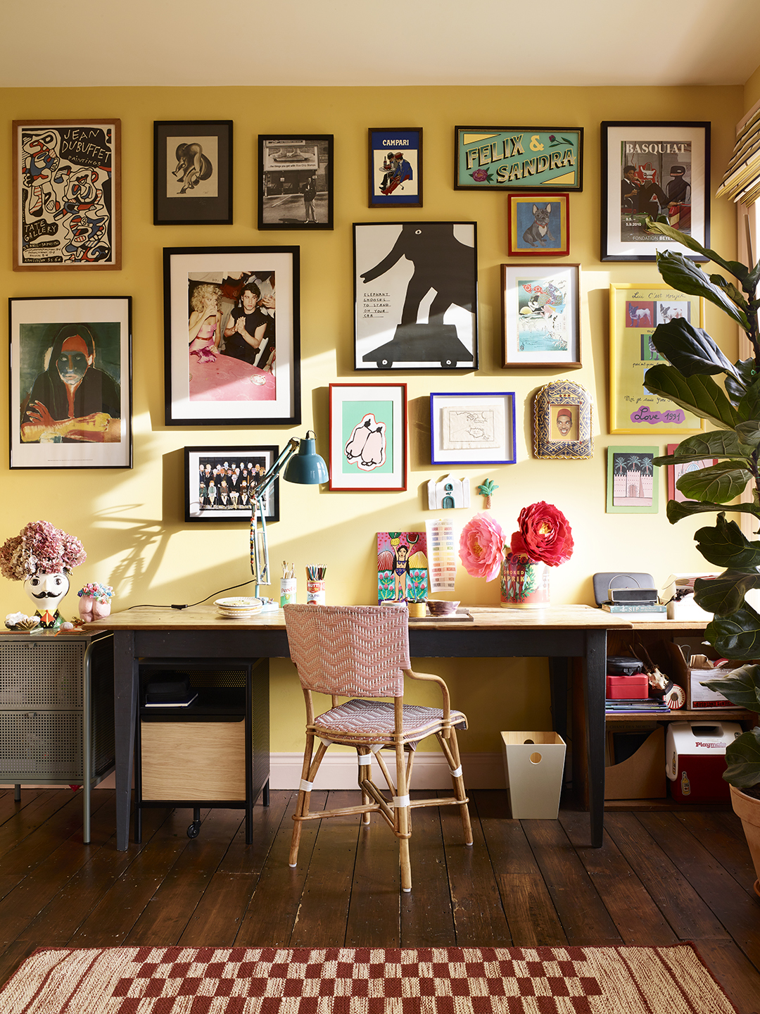 desk with pink chair and gallery wall