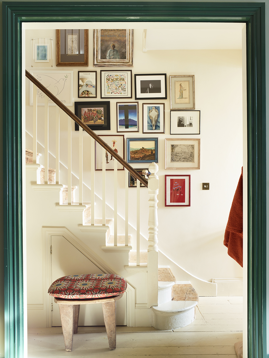 white staircase with red stool