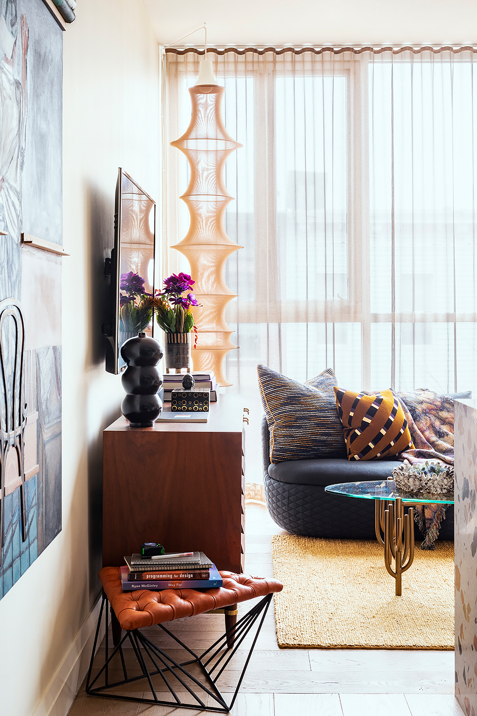 living room corner with jute rug and glass coffee table