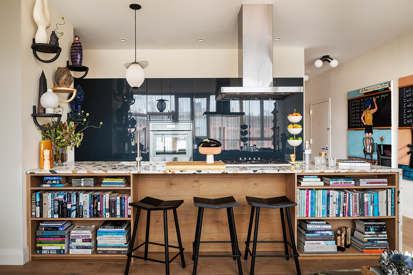 kitchen area with black bar stools and a wooden kitchen island