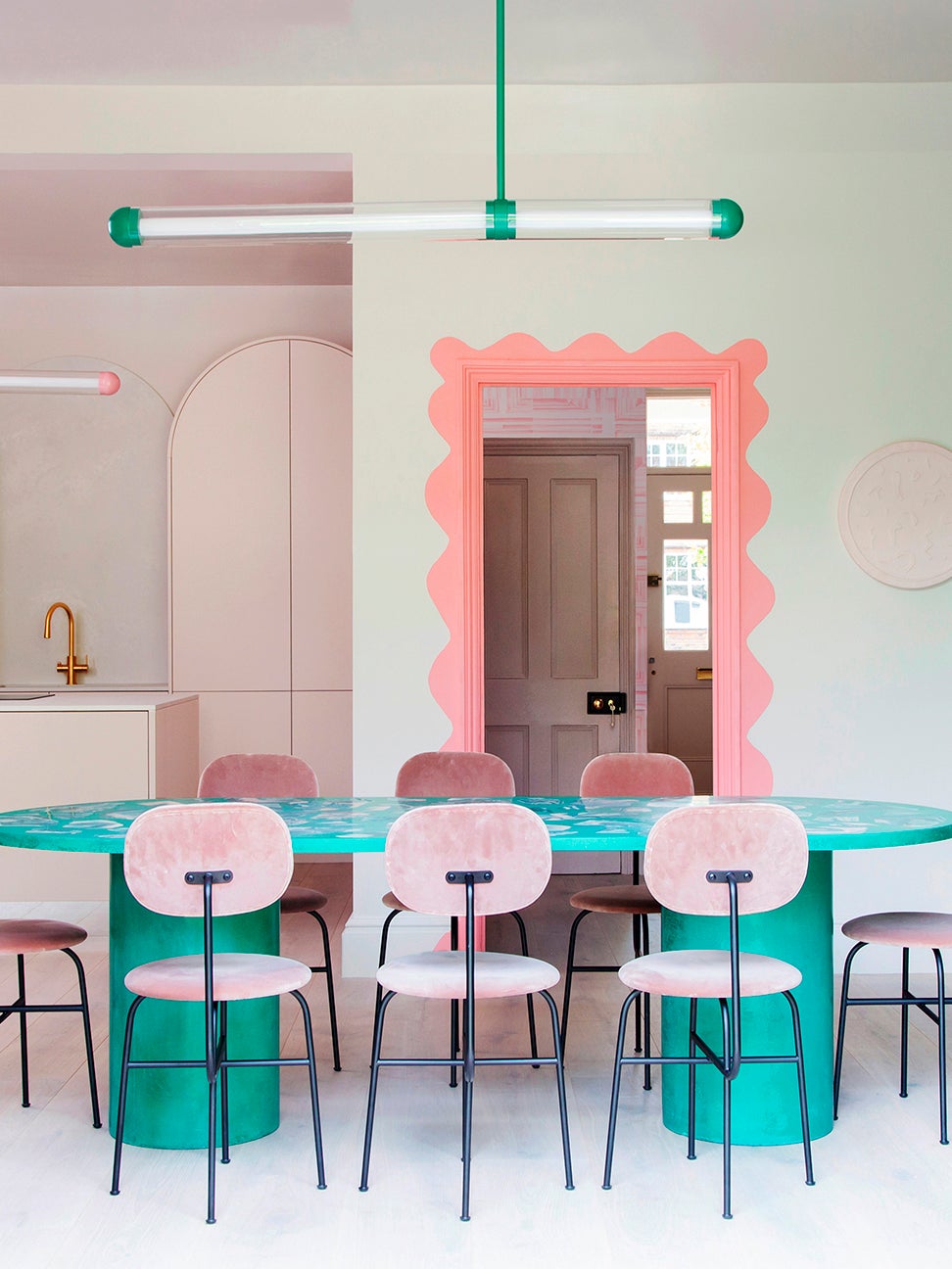 Pink dining chairs around custom dining table