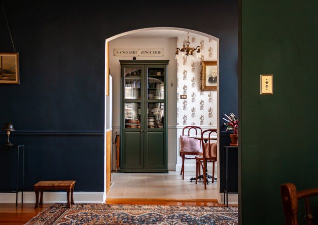 navy hallway with view of kitchen