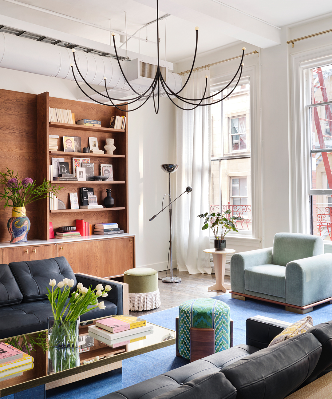 living room with blue furniture and wood bookshelves