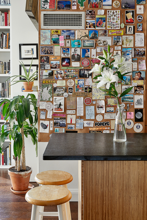 kitchen space with wall covered with cards and photos