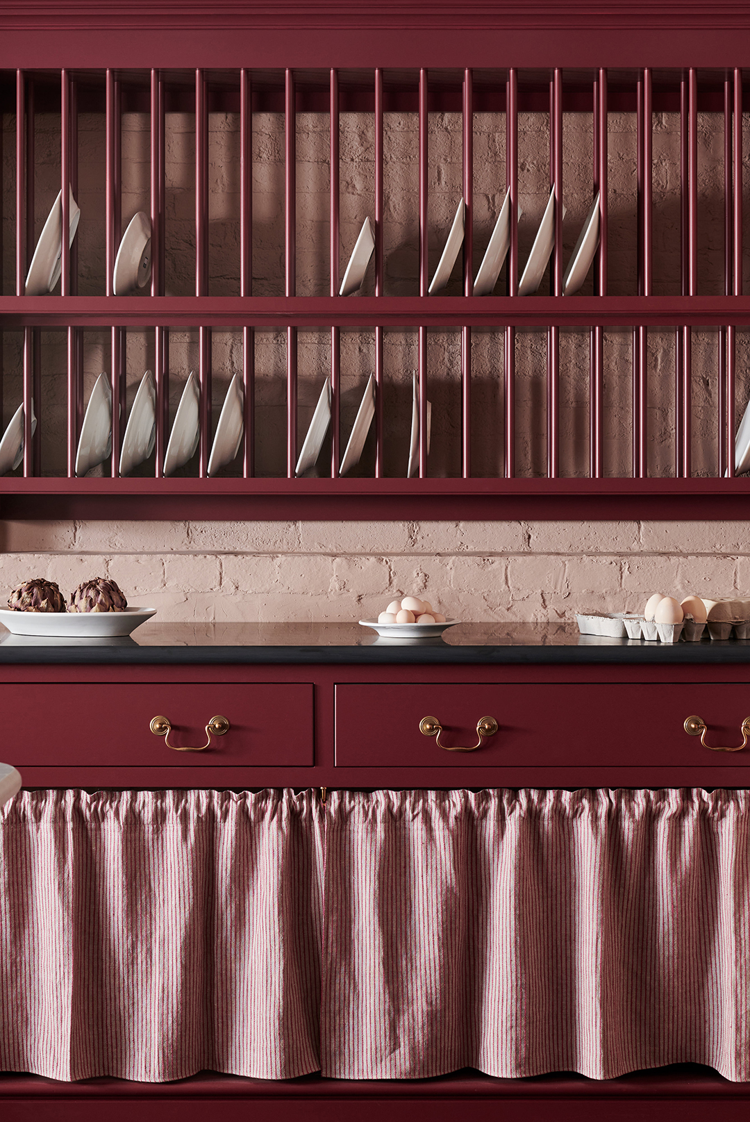 maroon plate rack and cabinets