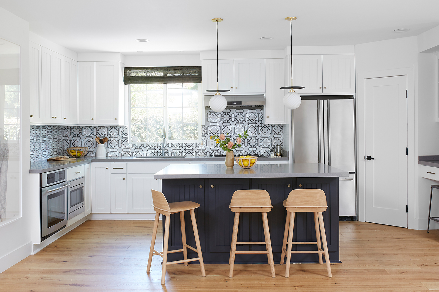 white kitchen with navy island