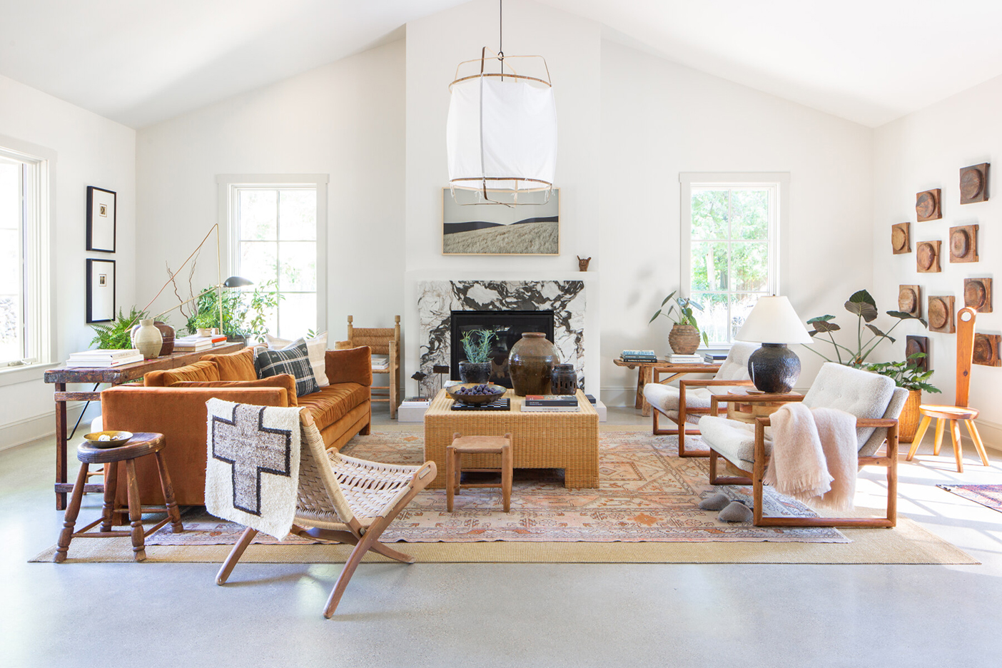 white living room with camel furniture and a marble fireplace