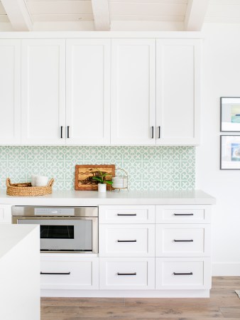 white kitchen with green backsplash