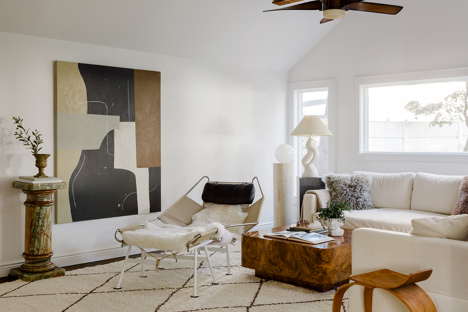 living room with white coach and chrome armchair