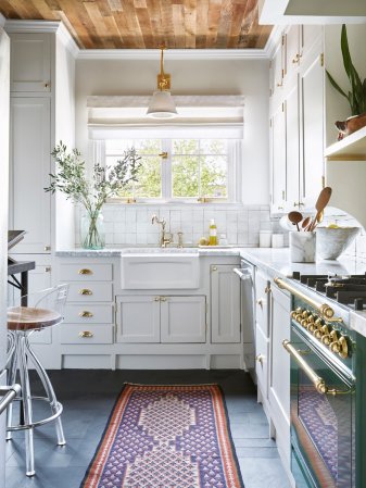 white kitchen with wood ceiling and white cabinets