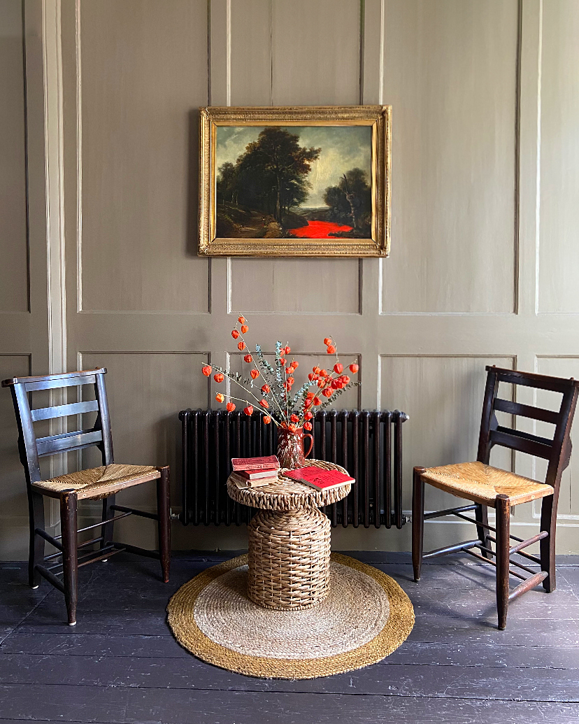 grey paneled wall with two dining chairs