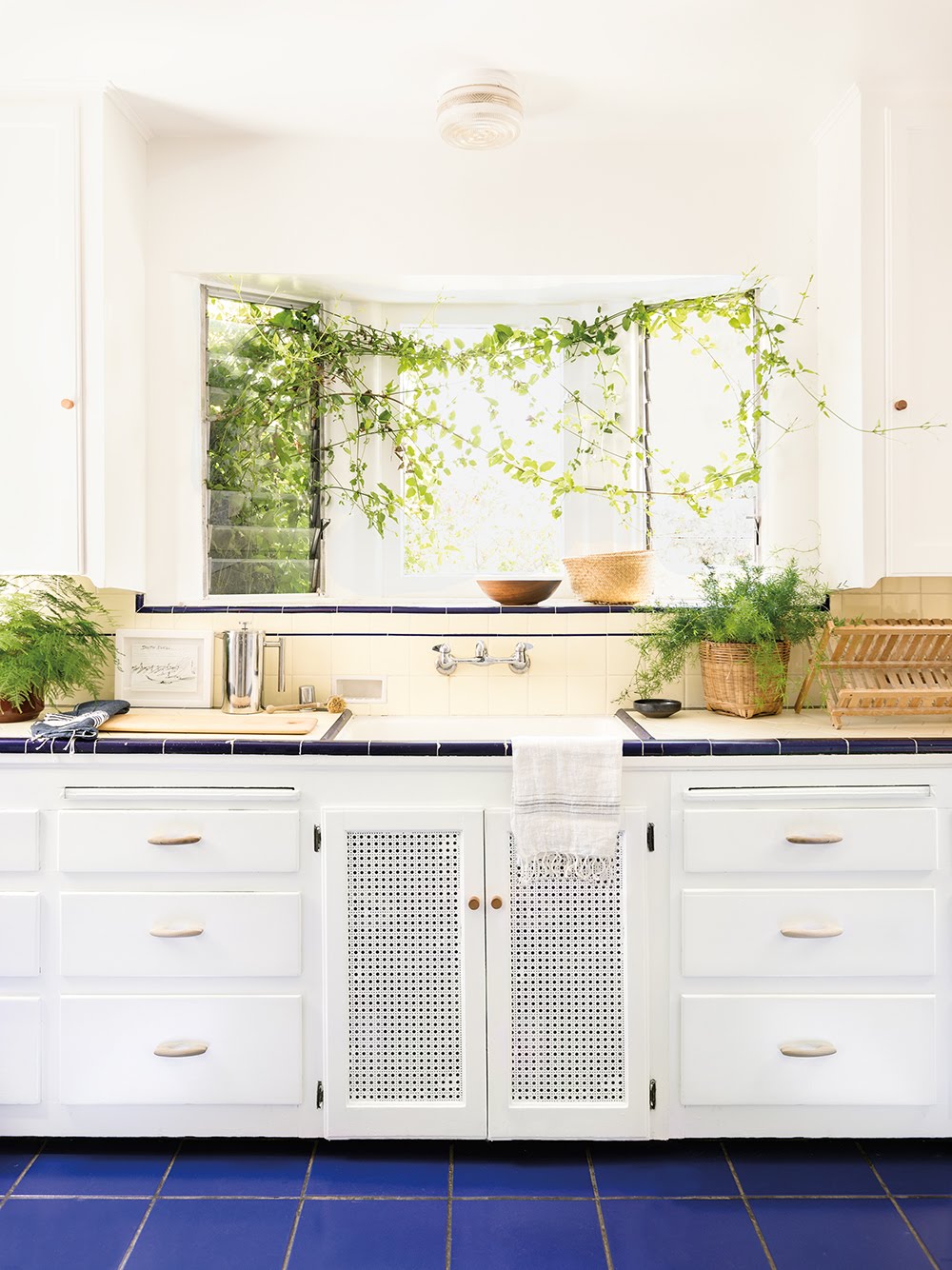 white kitchen cabinets with blue floor