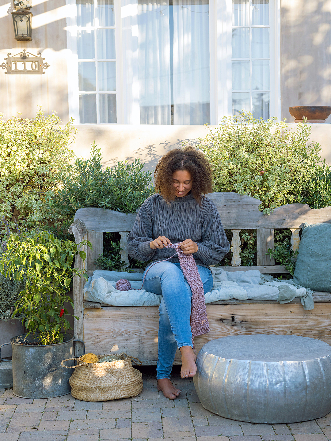 girl knitting on sofa