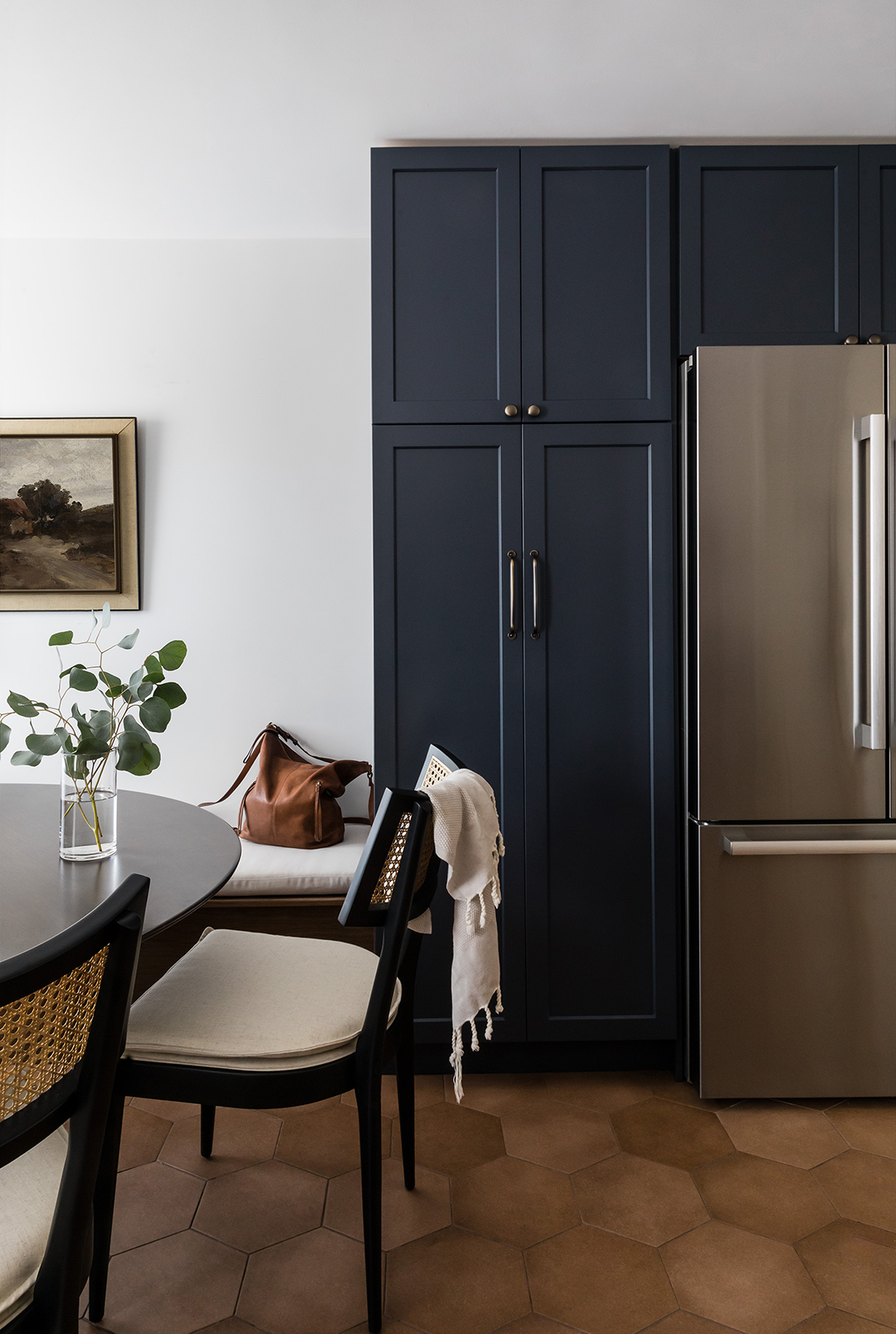 tall navy cabinets around fridge