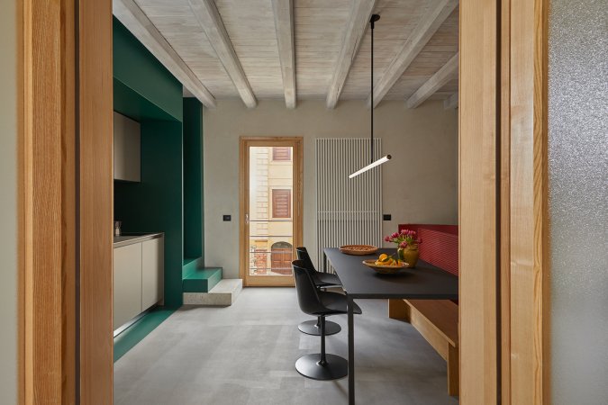 kitchen and dining room with green cabinets