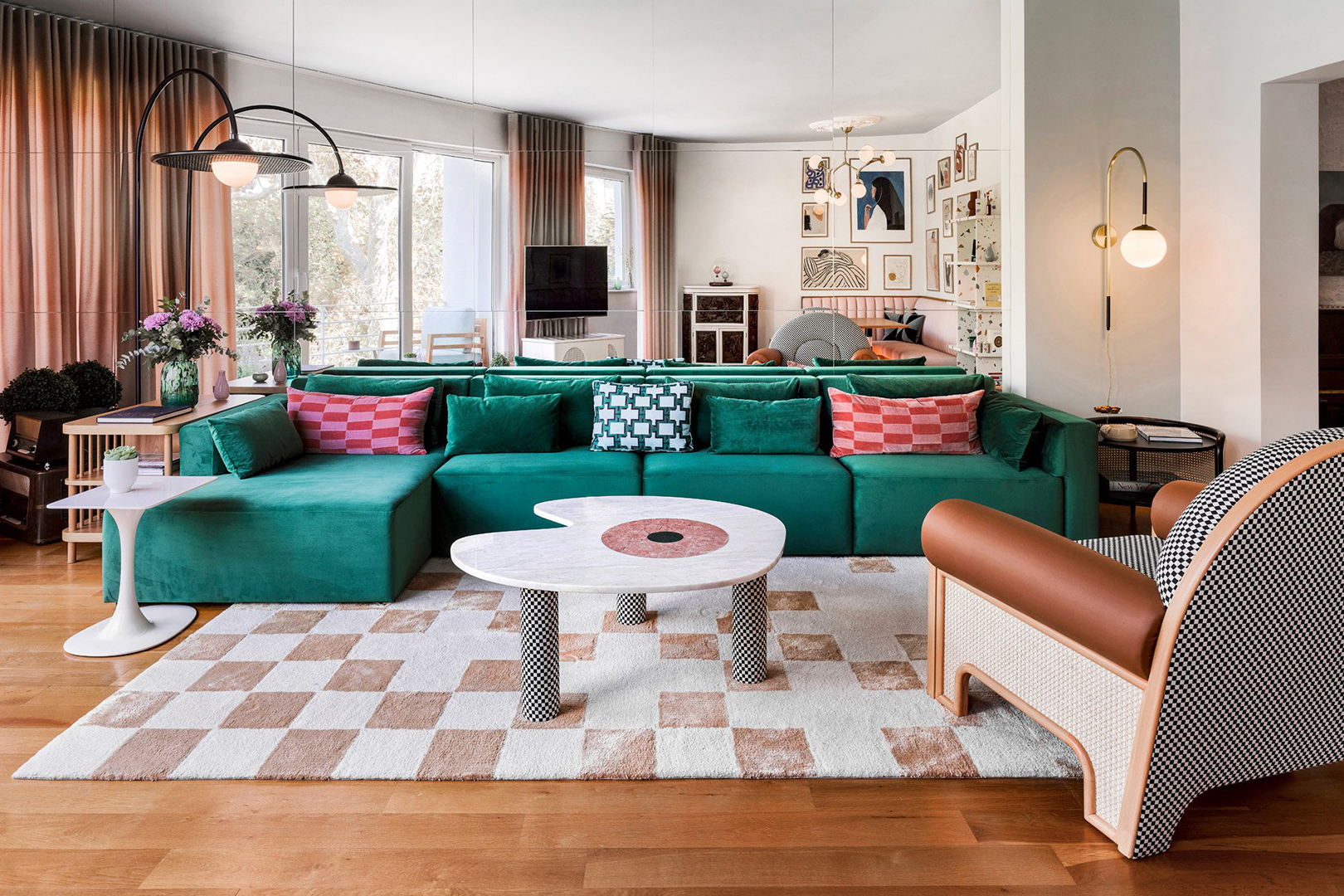 living room with mirrored wall and green sofa