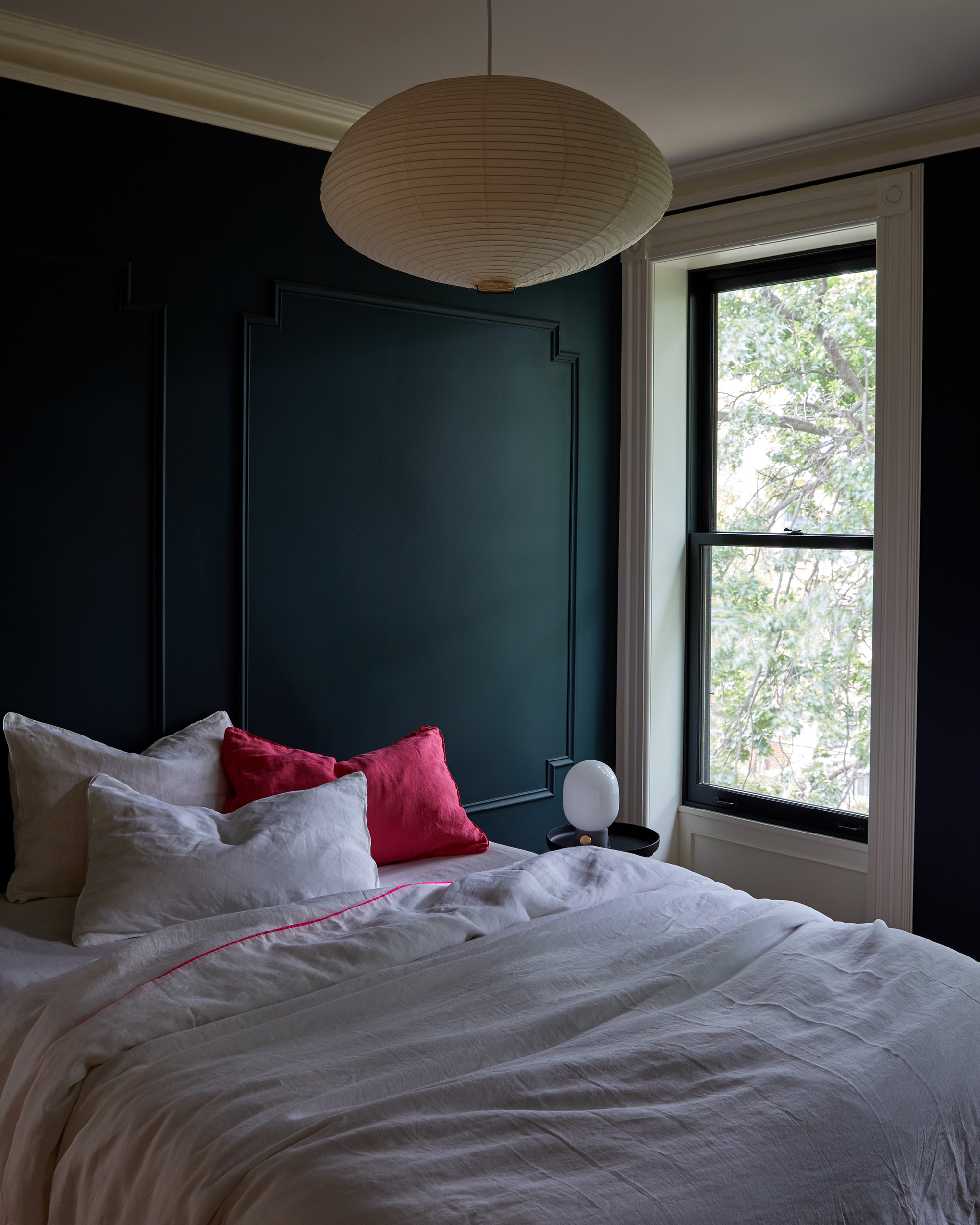 Green painted wall and white bedding bedroom