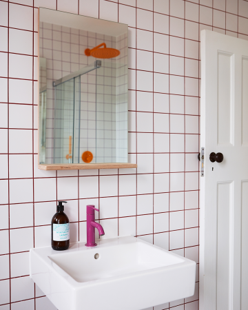 Purple Grout and a Mango Showerhead Infuse This Shared Family Bathroom With Fun