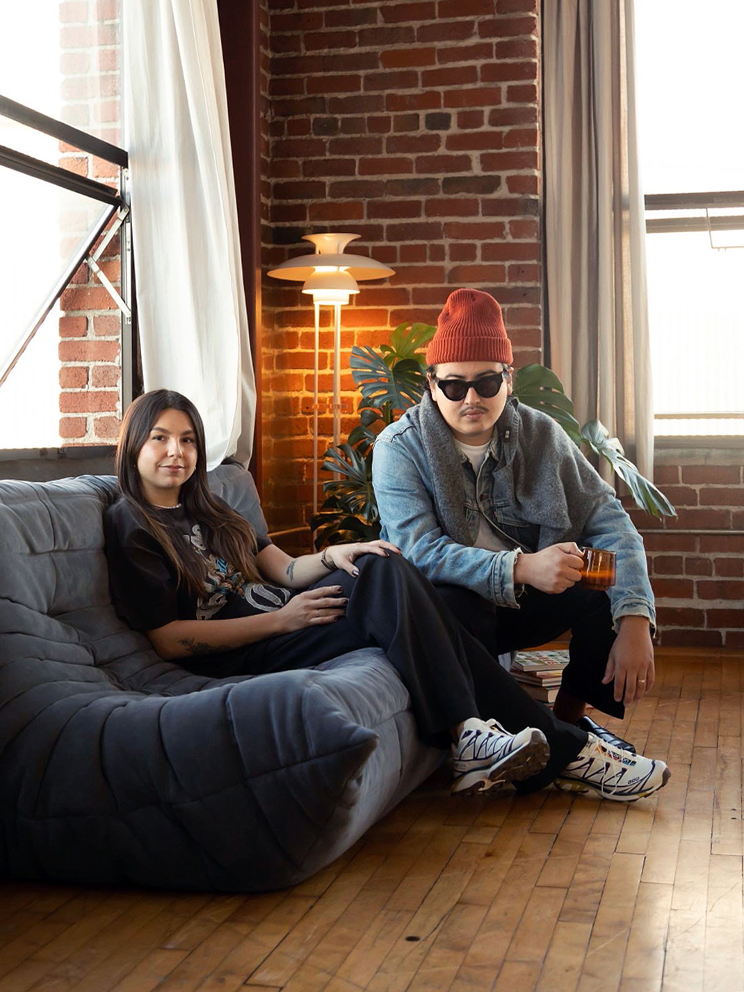 portrait of two people on a grey sofa