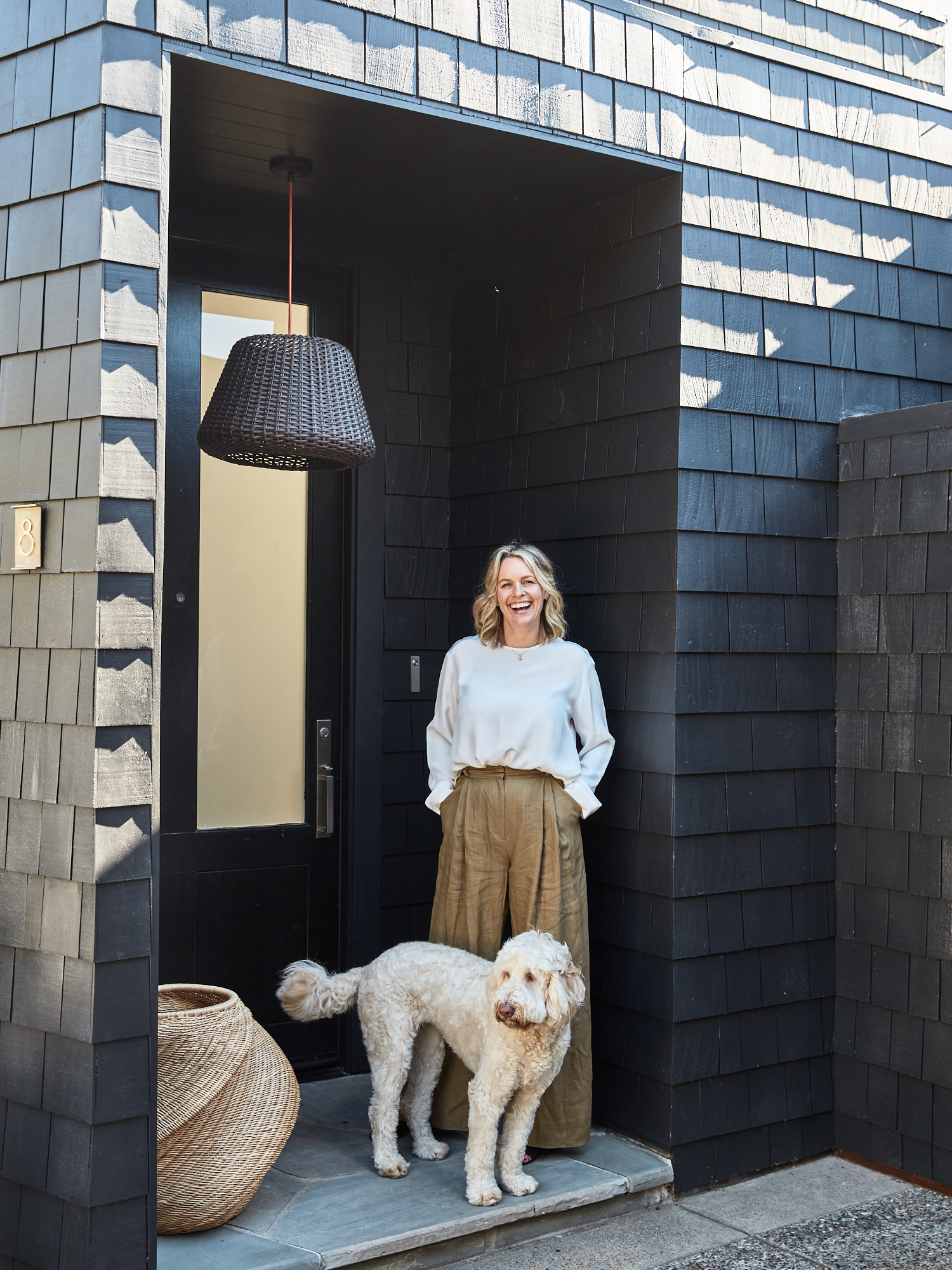 woman standing in front of house