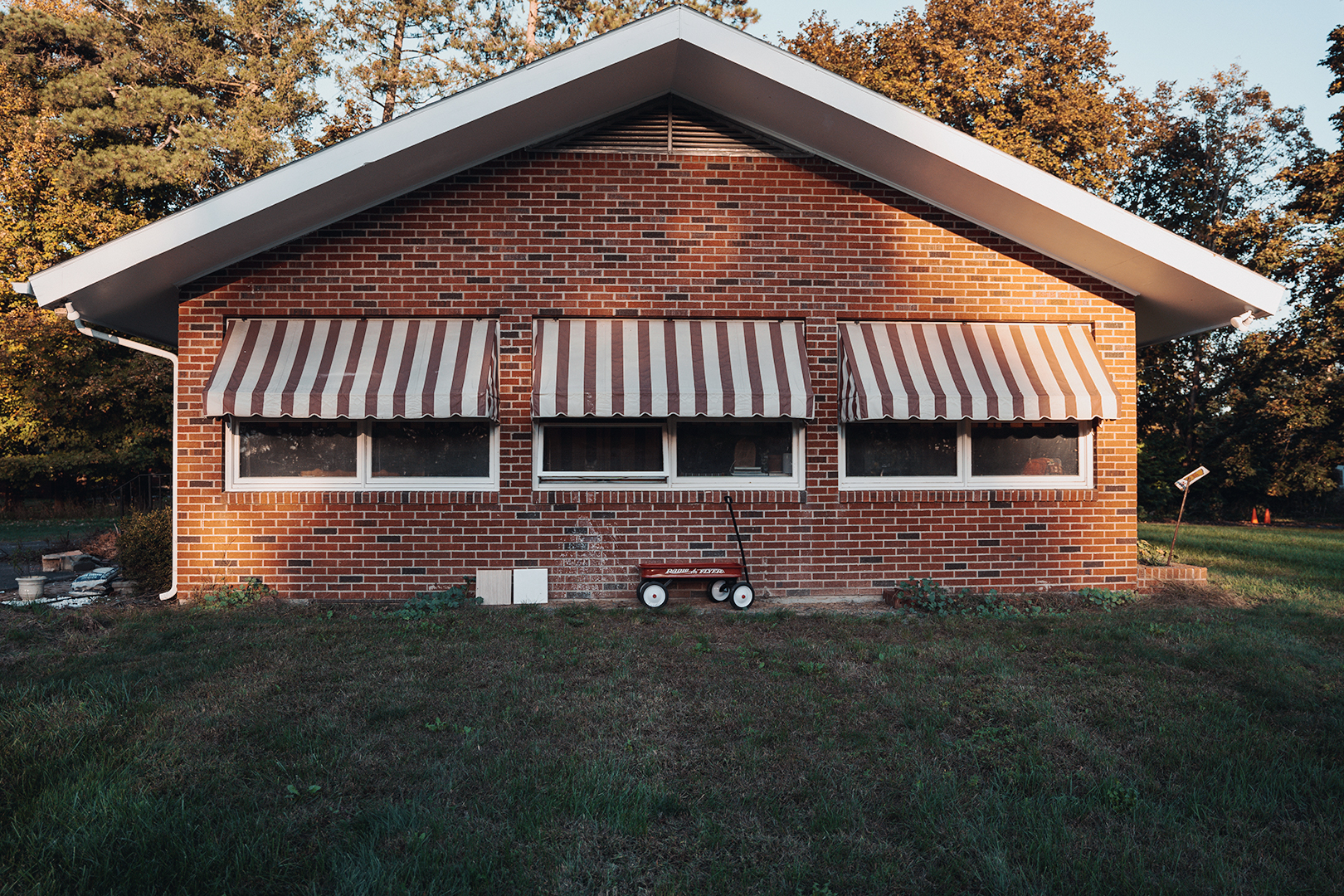 red brick building with striped awinings