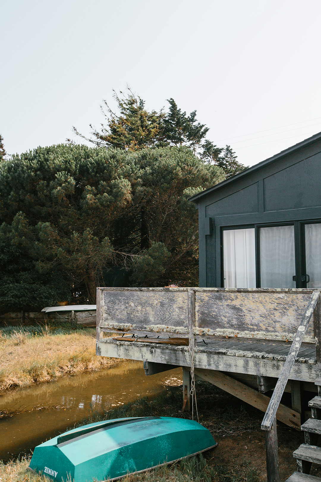 black house with worn down deck