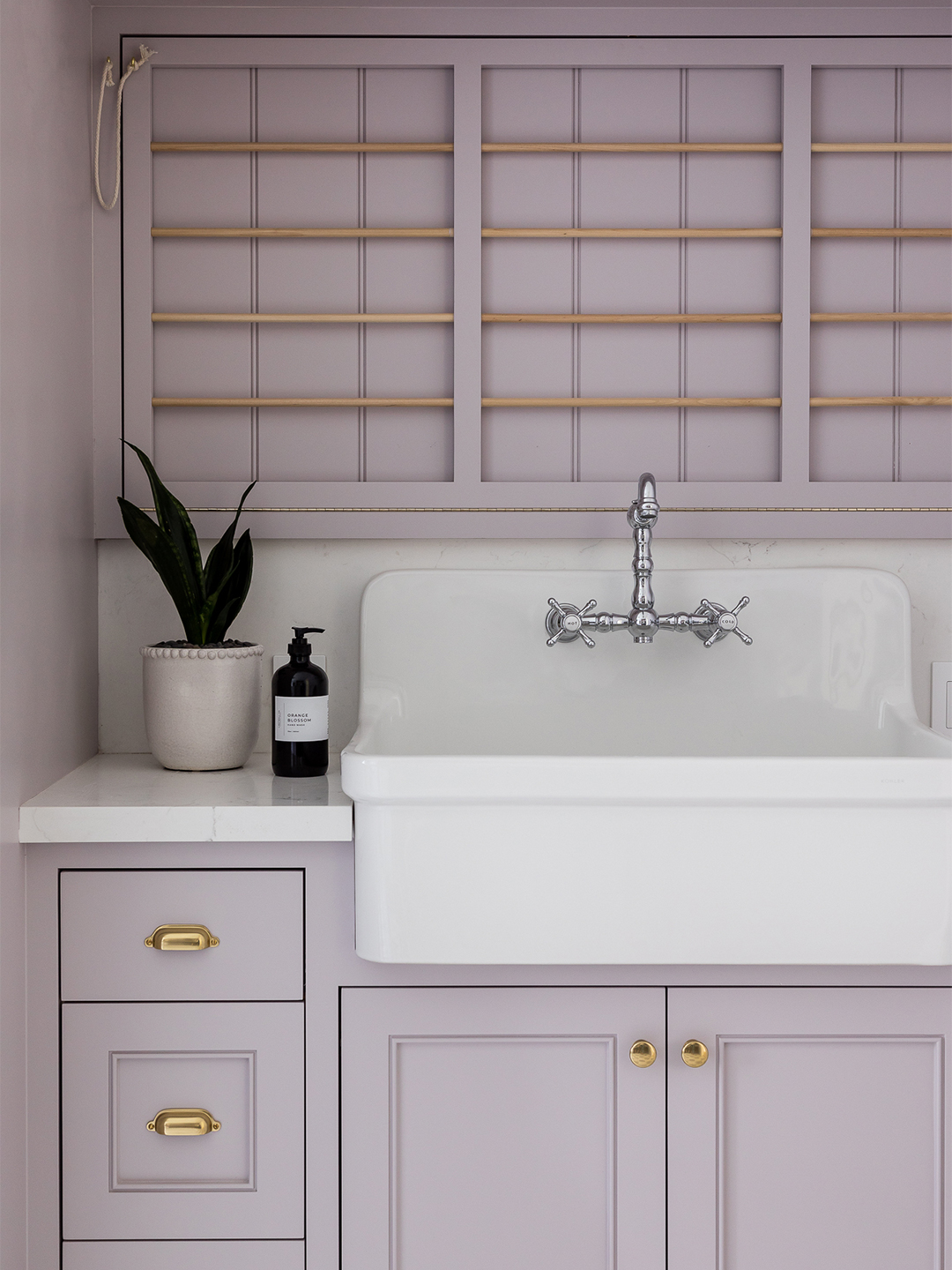 purplr laundry room with utility sink