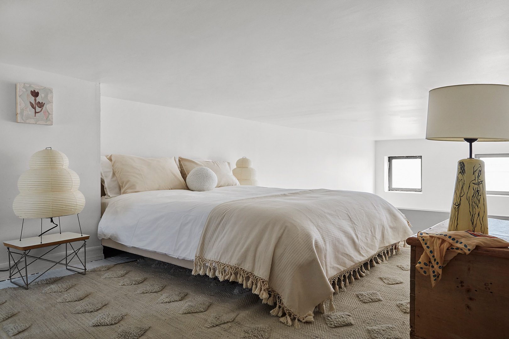 neutral bedroom with paper lantern