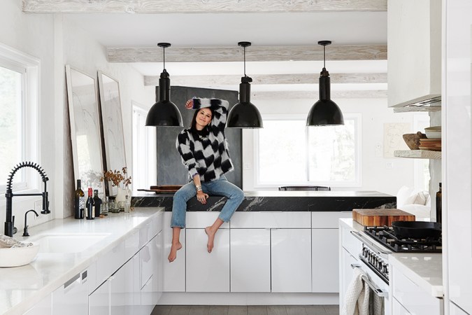 woman sitting on countertop