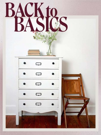 white chalk painted dresser next to wooden chair against white backdrop