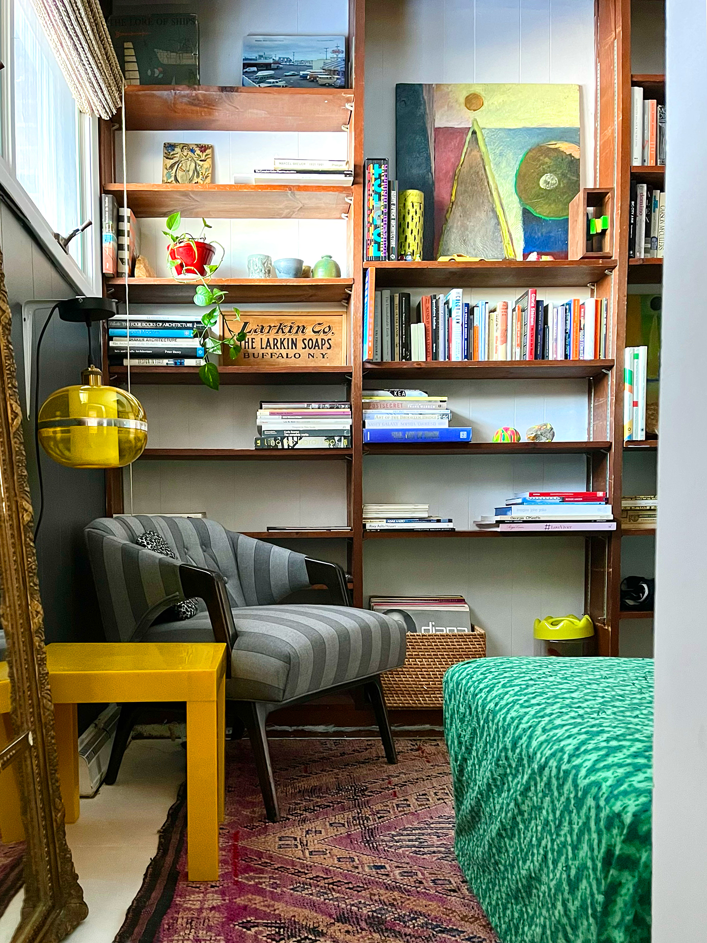 built-in wood shelves styled with colorful artwork and books