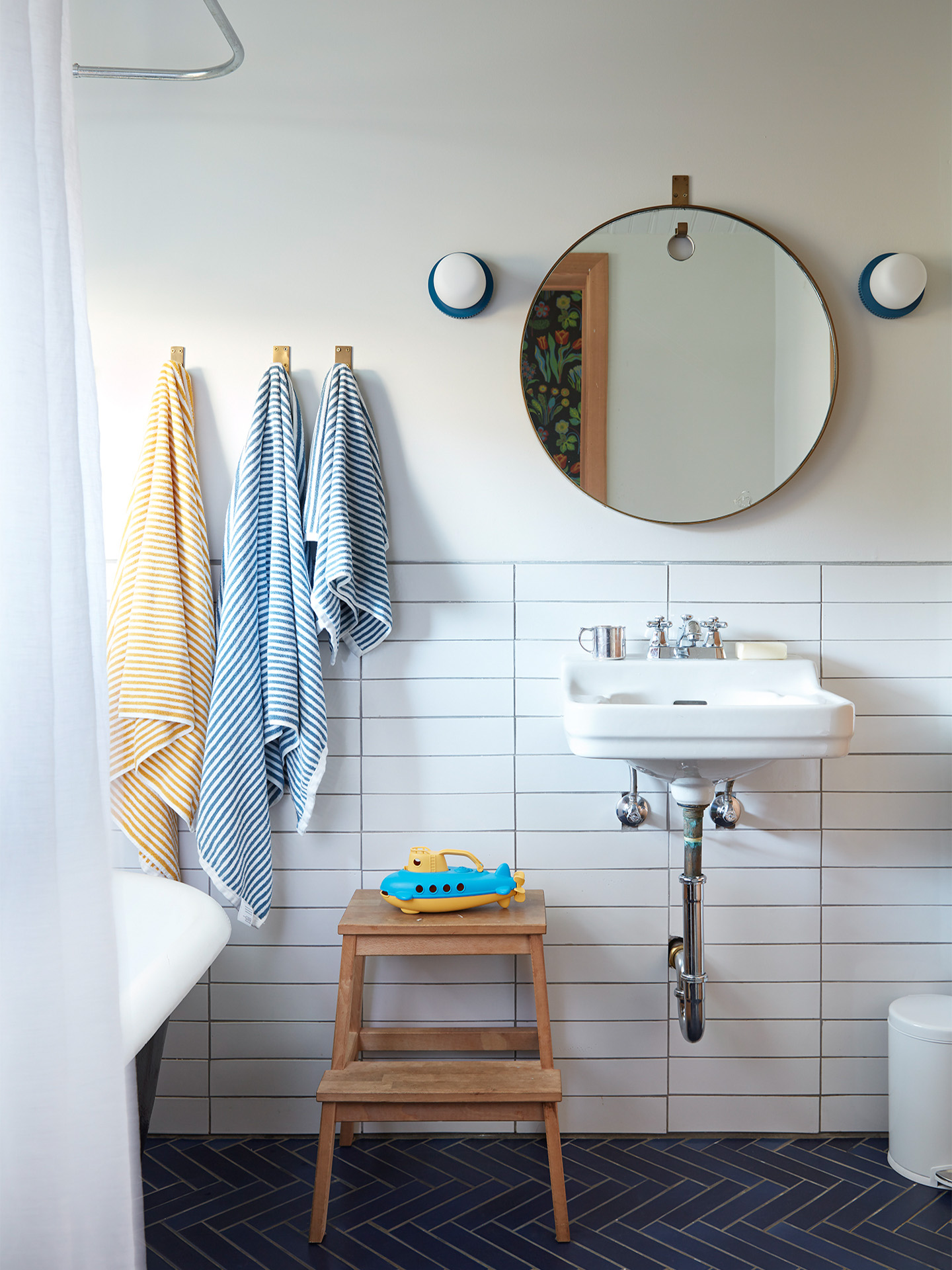 white tiled kids’ bathroom facing sink