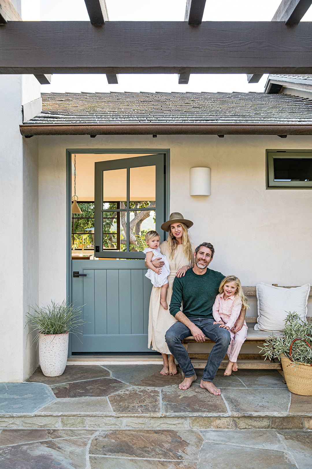 Couple standing outside their blue barn door