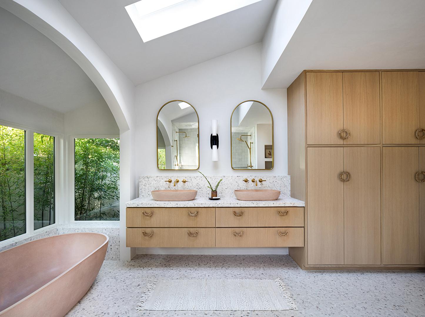 Bathroom with pink tub and sink basins