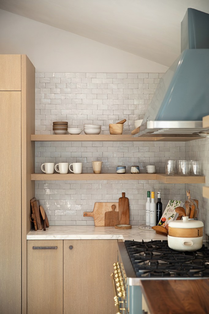 Open shelving in a kitchen with wooden cabinets