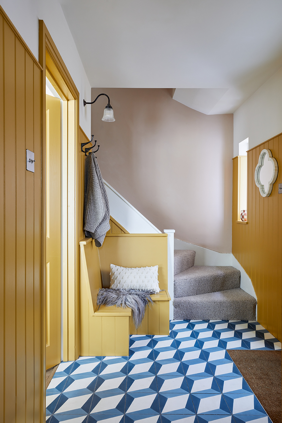 yellow entry with blue tile floor