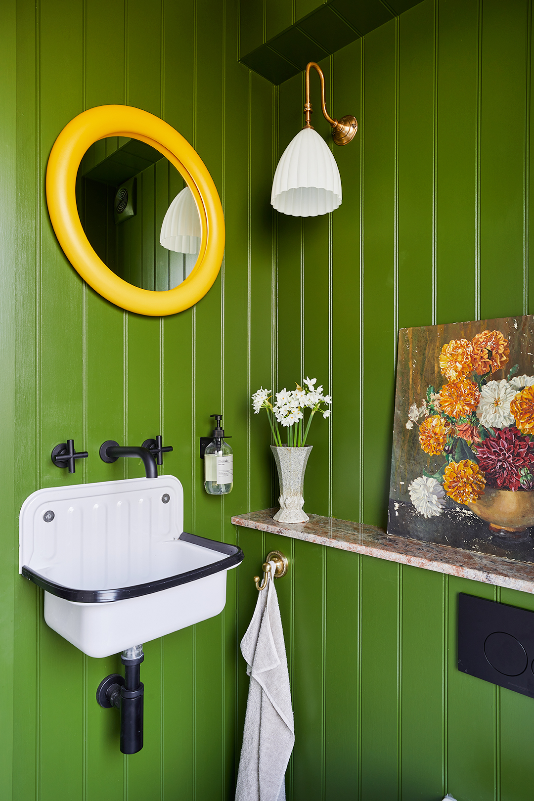 green paneled powder bathroom