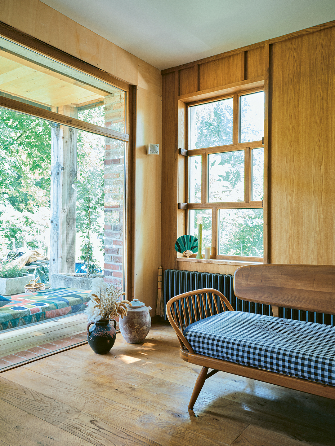 living room with gingham. bench and plywood walls