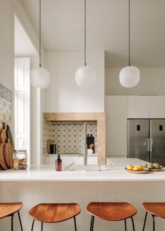 Kitchen with wooden Gubi stools and classic Portugese backsplash