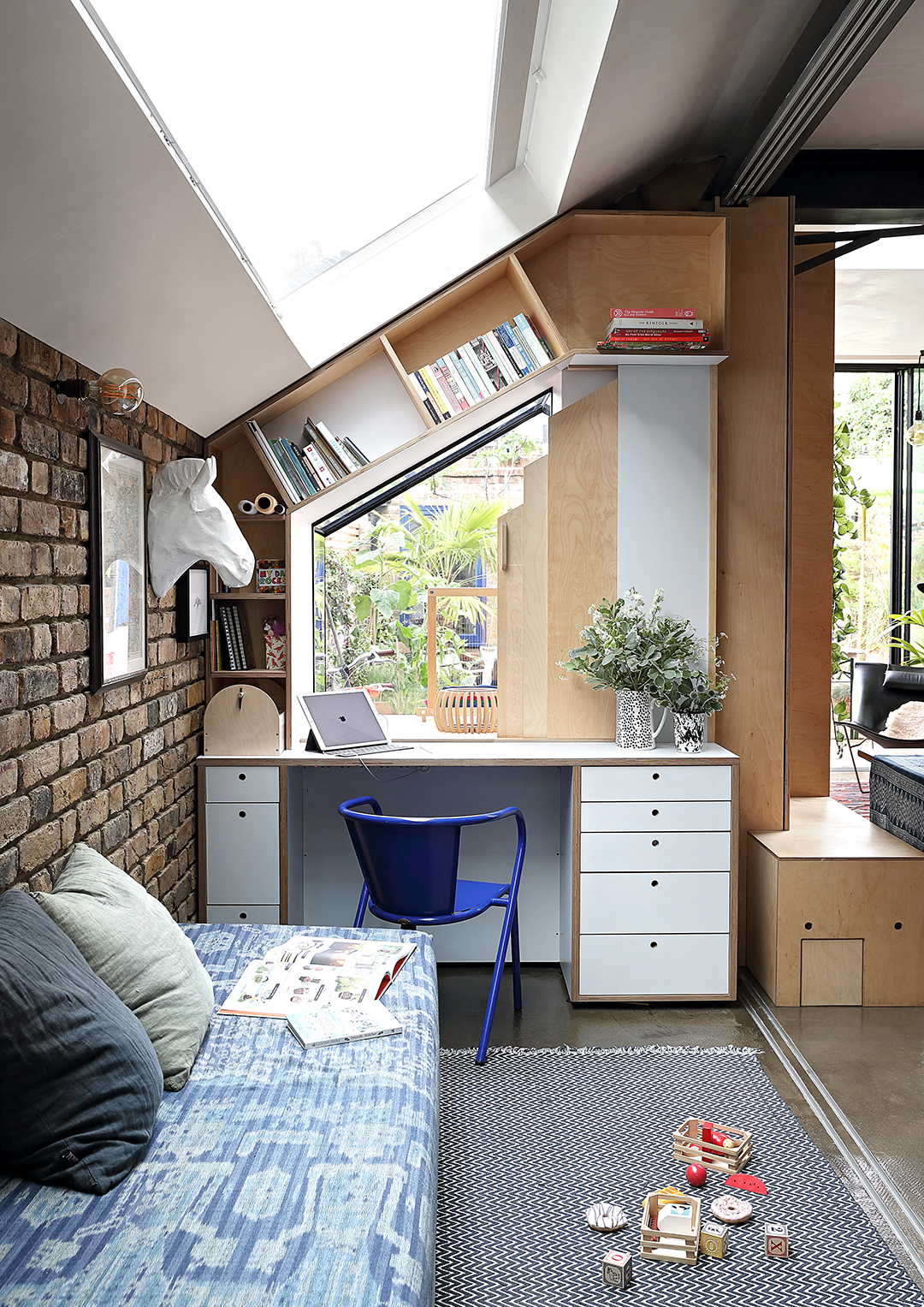 daybed next to desk with skylight overhead