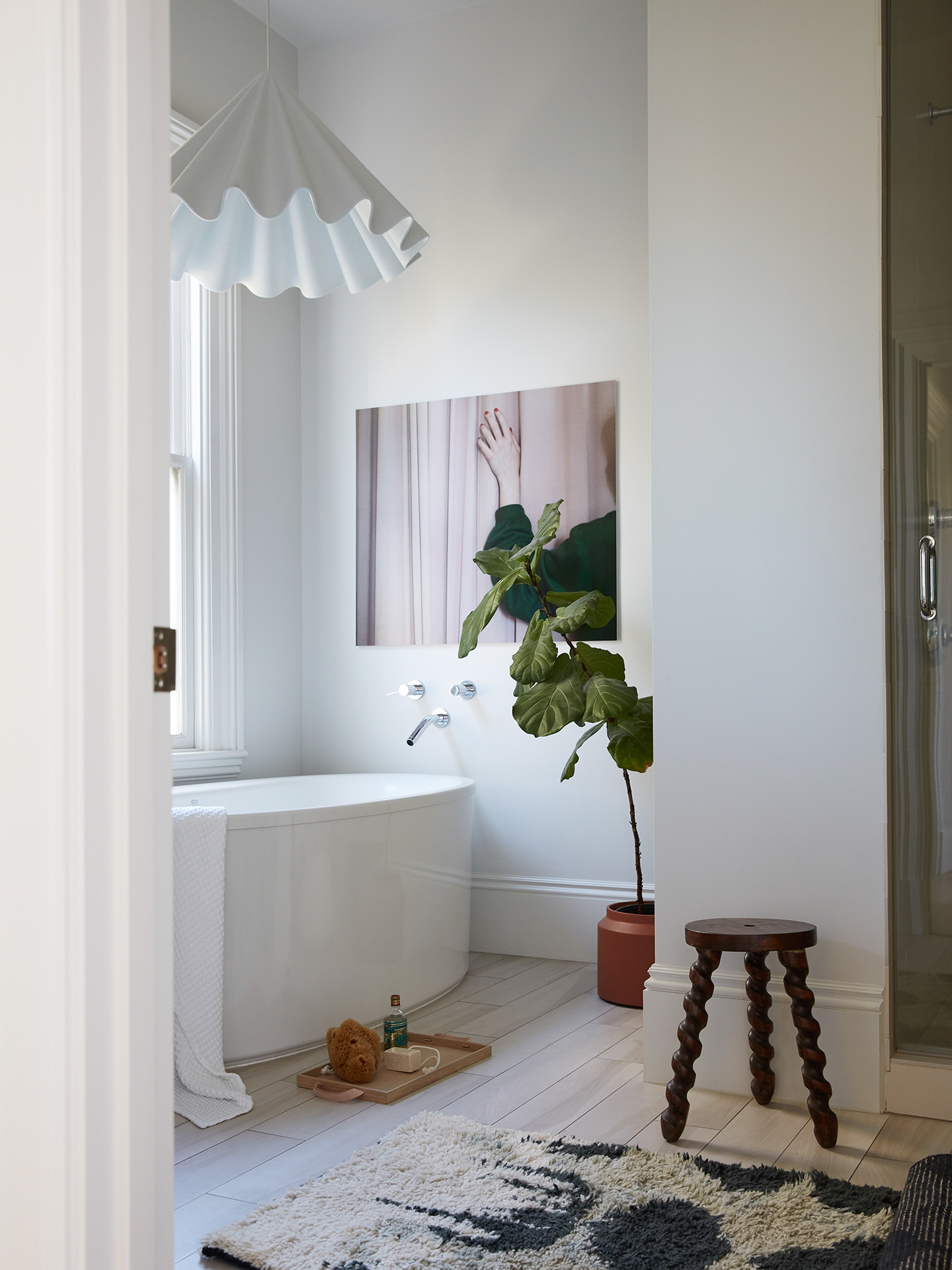 white bathroom with wavy pendant light