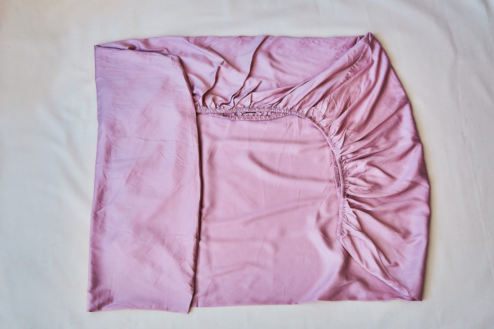 pink fitted folded sheet in a rectangle shape