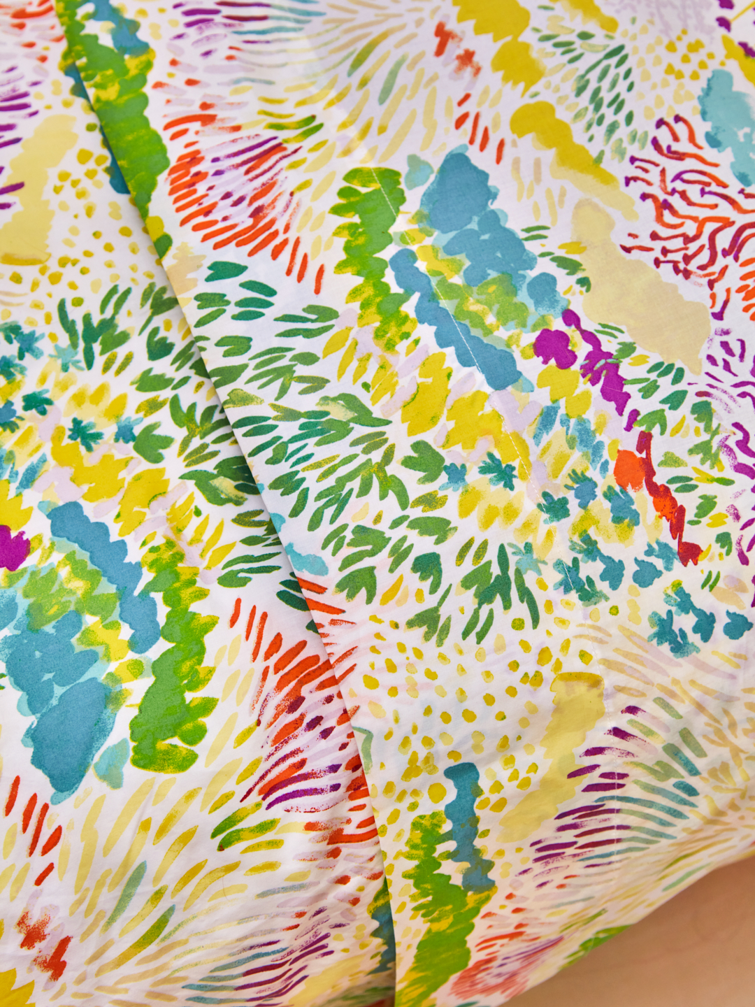 close up of folded down flower patterned comforter