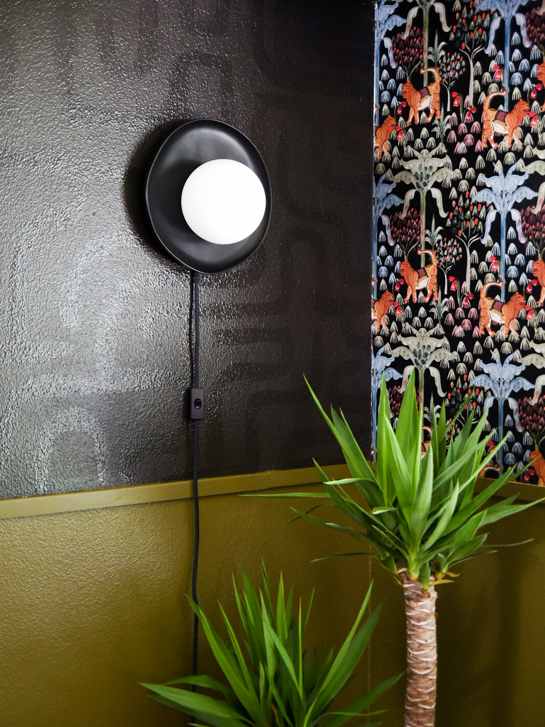 ceramic sconce on black wall