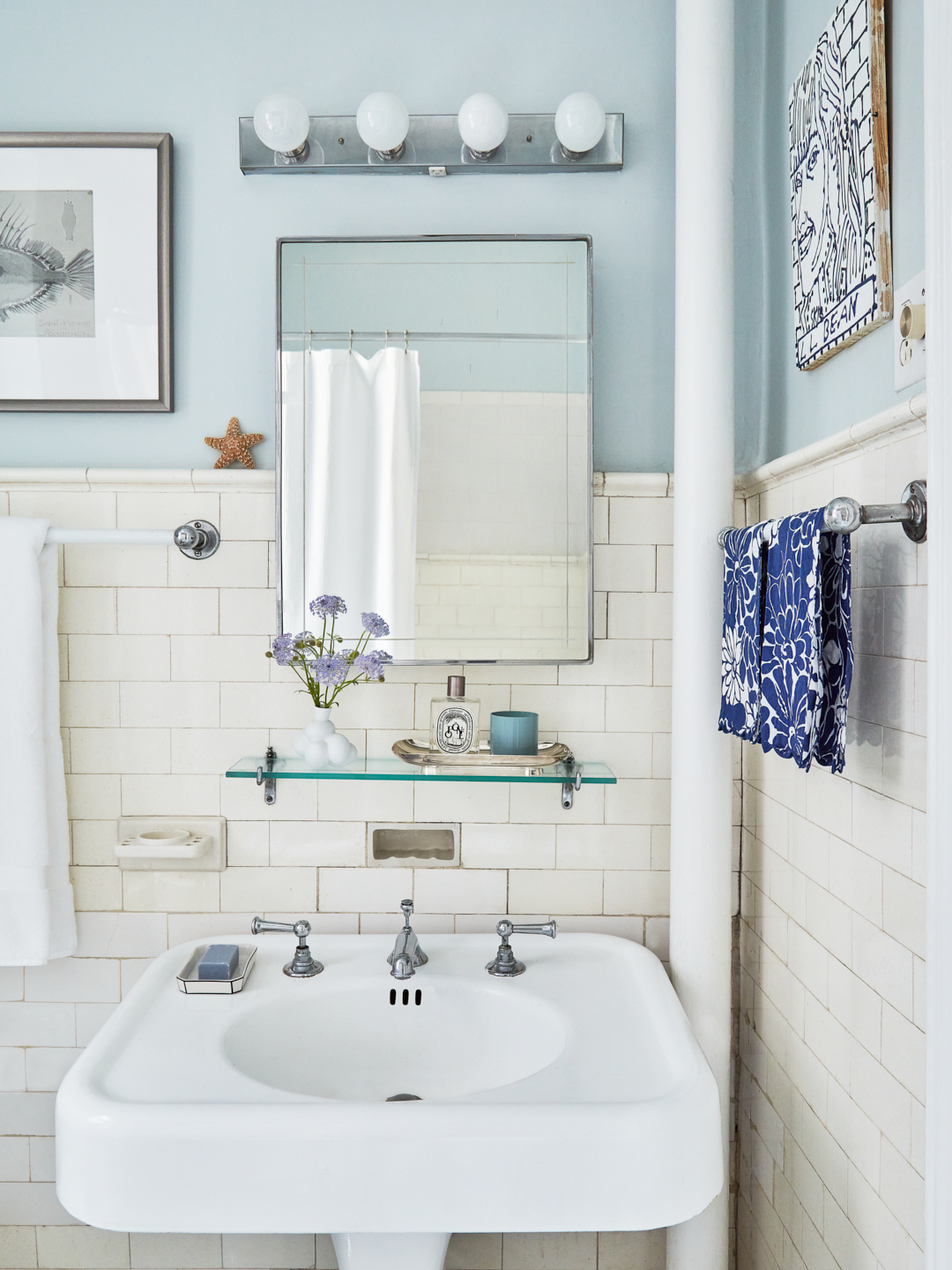 bathroom with blue walls and white pedestal sink.