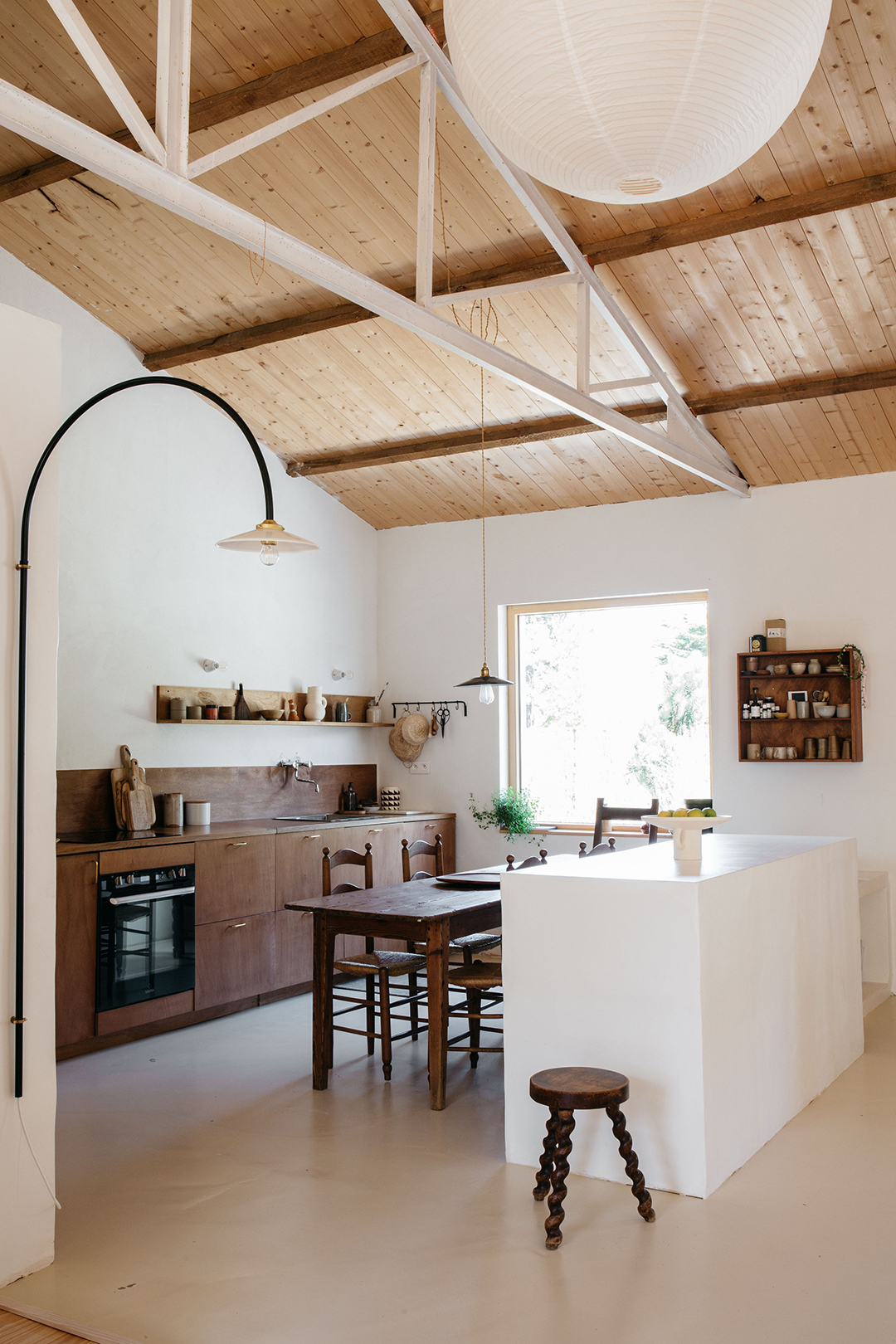 Kitchen with white island and dining table