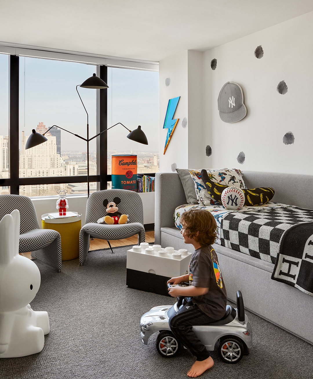 black and white kid’s room with boy on mini car